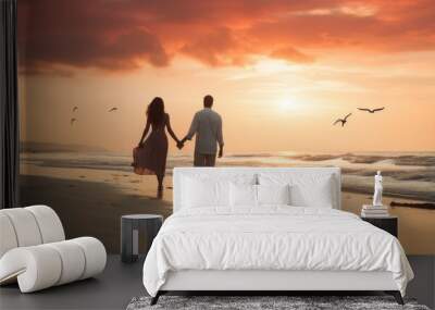 Couple walking along a beach on a romantic evening Wall mural