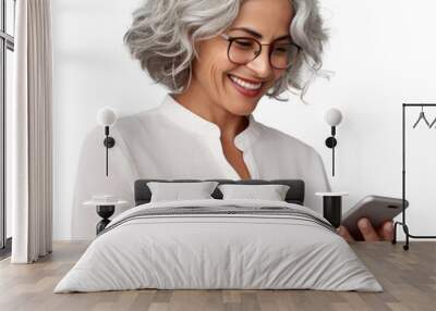 Older woman smiling and looking at her smartphone, transparent background (PNG) Wall mural