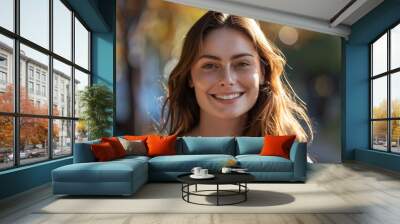 Outdoor portrait of a smiling Caucasian woman with long brown hair Wall mural