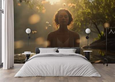 Young black woman meditating outdoors. Concept of inner peace, living a healthy lifestyle, and self care. Wall mural