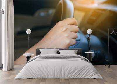 Hands of female driver on steering wheel,Woman driving a car,Close-up Wall mural