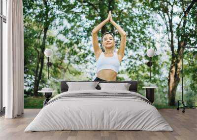 Young girl doing or practicing yoga at outdoor in the morning,Relaxing time,Meditation concept Wall mural