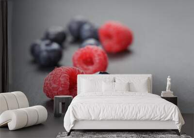 closeup photo of fresh organic raspberries and blueberries Wall mural