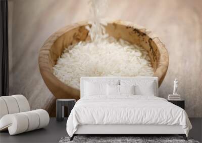 dry basmati rice fall in wood bowl on table Wall mural