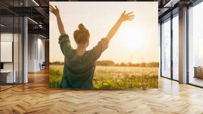 female teen girl stand feel freedom with arms stretched to the sky Wall mural