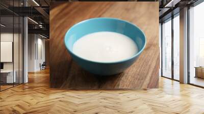 fresh milk in the blue bowl on wood table, organic food Wall mural