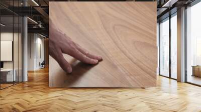 man hand touches black walnut dining table surface Wall mural