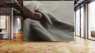 man hand touching green cotton fabric Wall mural