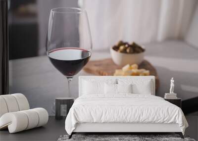 Red wine with olives and vintage cheese on white table Wall mural