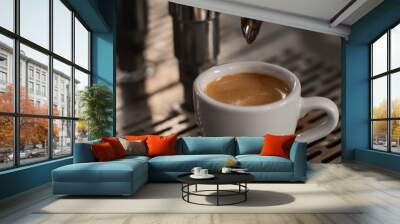 White cup with espresso on coffee machine tray Wall mural