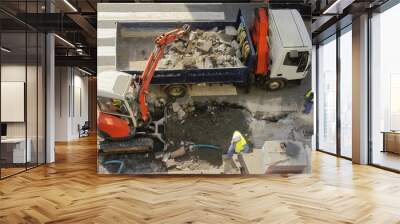 bulldozer excavator machine industry picks up debris on city str Wall mural