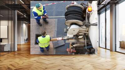 workers moves the manhole cover to cleaning the sewer line Wall mural