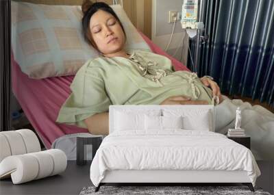 pregnant woman patient is sleeping on bed in hospital Wall mural