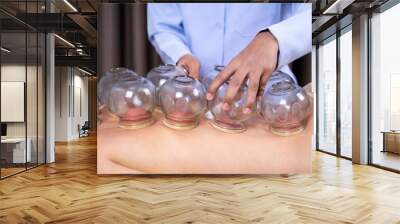 woman receiving cupping treatment on back Wall mural