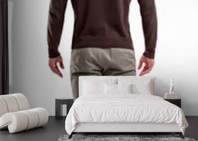 A back view on a modern fit and casually clothed man that stands in a relaxed posture completely straight. Wall mural