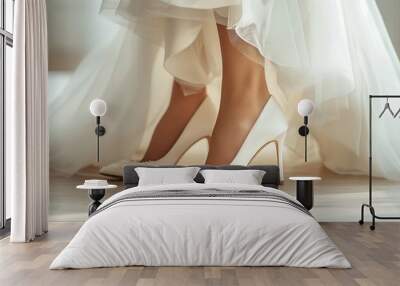 Close-up image capturing the details of elegant white heels worn by a bride, paired with a flowing wedding dress at floor level Wall mural