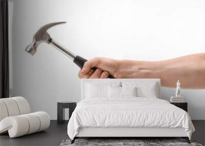 Close-up view of a man's hand holding hammer, isolated on white background Wall mural