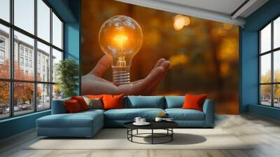 Hand silhouetted by autumn bulb light Wall mural