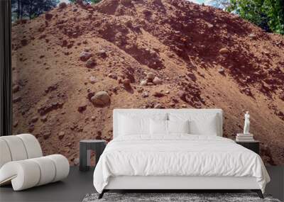 A mountain of sand and stones. Material for building a house in the village. Sand and gravel mixture for leveling a construction site, making the foundation of a building or a drainage layer.  Wall mural