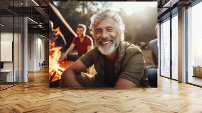 Diverse group of middle aged male friends camping together in the forest Wall mural