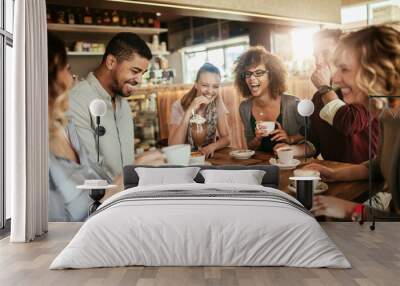 group of happy friends having coffee together in cafe or bar Wall mural