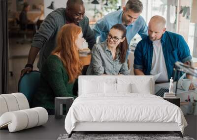 Group of people working together on a project in a startup company office Wall mural