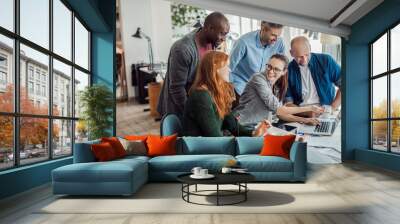 Group of people working together on a project in a startup company office Wall mural