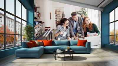 Group of people working together on a project in a startup company office Wall mural