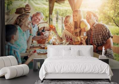 Happy family enjoying meal together in vineyard Wall mural