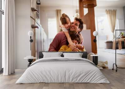 Happy young dad having fun with his kids on the floor at home Wall mural