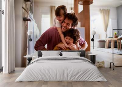 Happy young dad having fun with his kids on the floor at home Wall mural