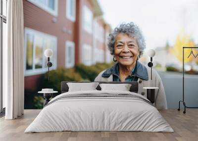 Portrait of a senior african american woman standing outside of her nursing home and looking at the camera Wall mural