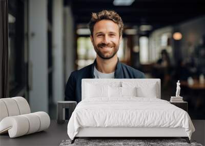 Portrait of a smiling young caucasian man working in a startup company office Wall mural