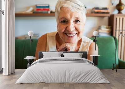 Smiling elderly woman portrait in a living room Wall mural