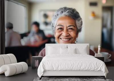 Smiling portrait of a happy senior latin or mexican woman in a nursing home Wall mural