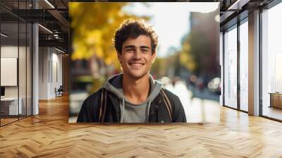 Smiling portrait of a young happy caucasian male student on a college campus Wall mural