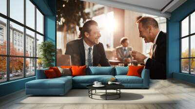 Two businessmen having a meeting at a indoor cafe and having a discussion Wall mural