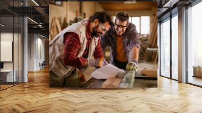 Two male carpenters working in a wood shop Wall mural