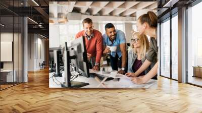 Young and diverse group colleagues working on a project together in a marketing company office Wall mural