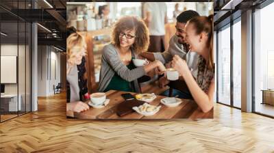 Young and diverse group of friends talking while having coffee together in a cafe Wall mural