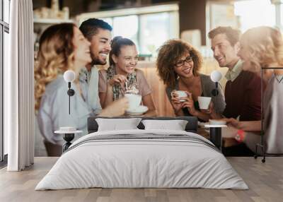 Young and diverse group of people talking and having coffee together in a cafe Wall mural