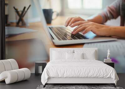 Young caucasian woman using laptop while working and studying at home Wall mural