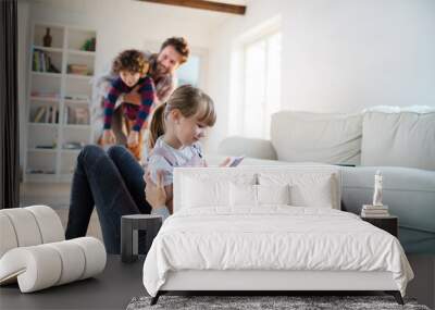 Young girl taking a picture of her mother on the living room floor Wall mural