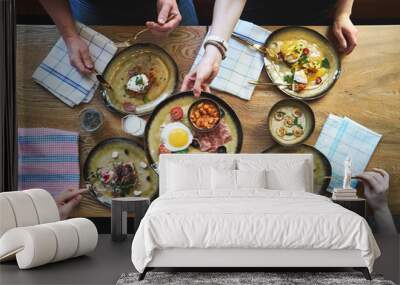 Group of people having breakfast and sitting at table, top view Wall mural