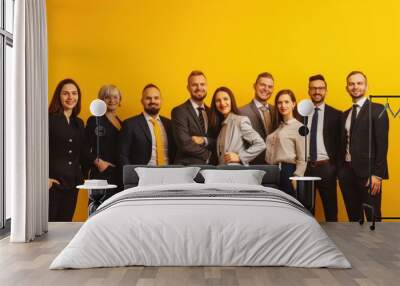 Team of business people on yellow background Wall mural