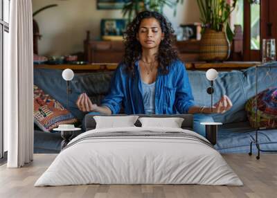 Young yogi Indian Woman Meditating on the couch, zen pose Wall mural