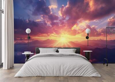 Dramatic sunset sky with scattered clouds, illuminating mountain range below with mystical light beams. Wall mural