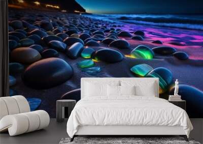 beautiful beach colored stones in the beach side with waves at the night, phosphorus stones, colored beach stones background Wall mural