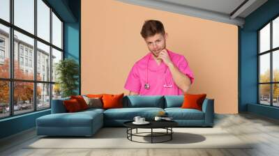 African doctor wearing a pink uniform on a yellow background Wall mural