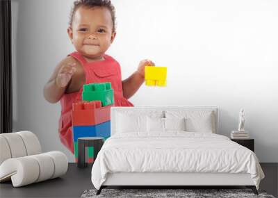 Baby girl playing with building blocks over white background Wall mural